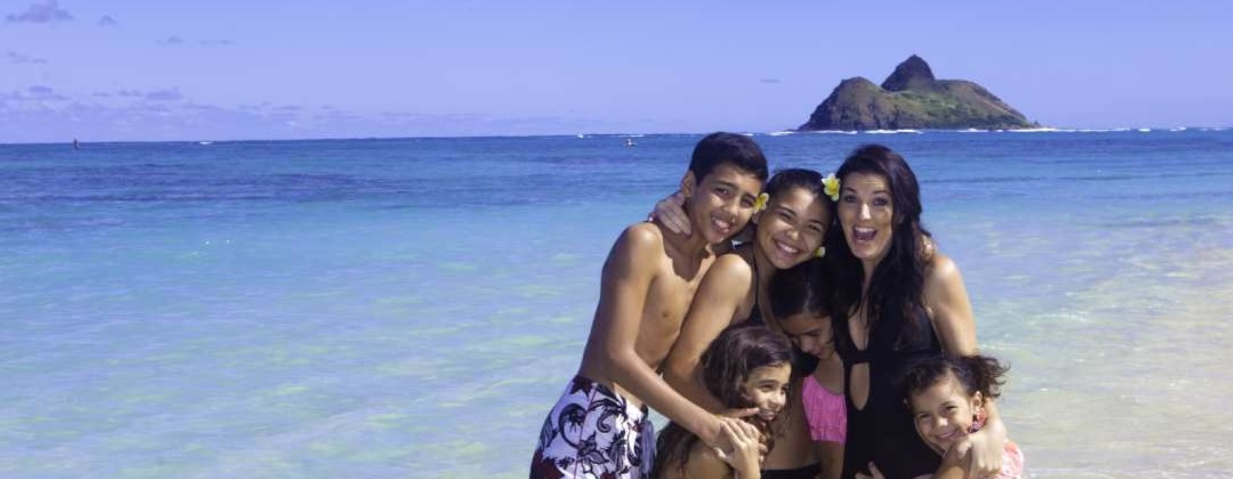 Family on the beach for personal insurance